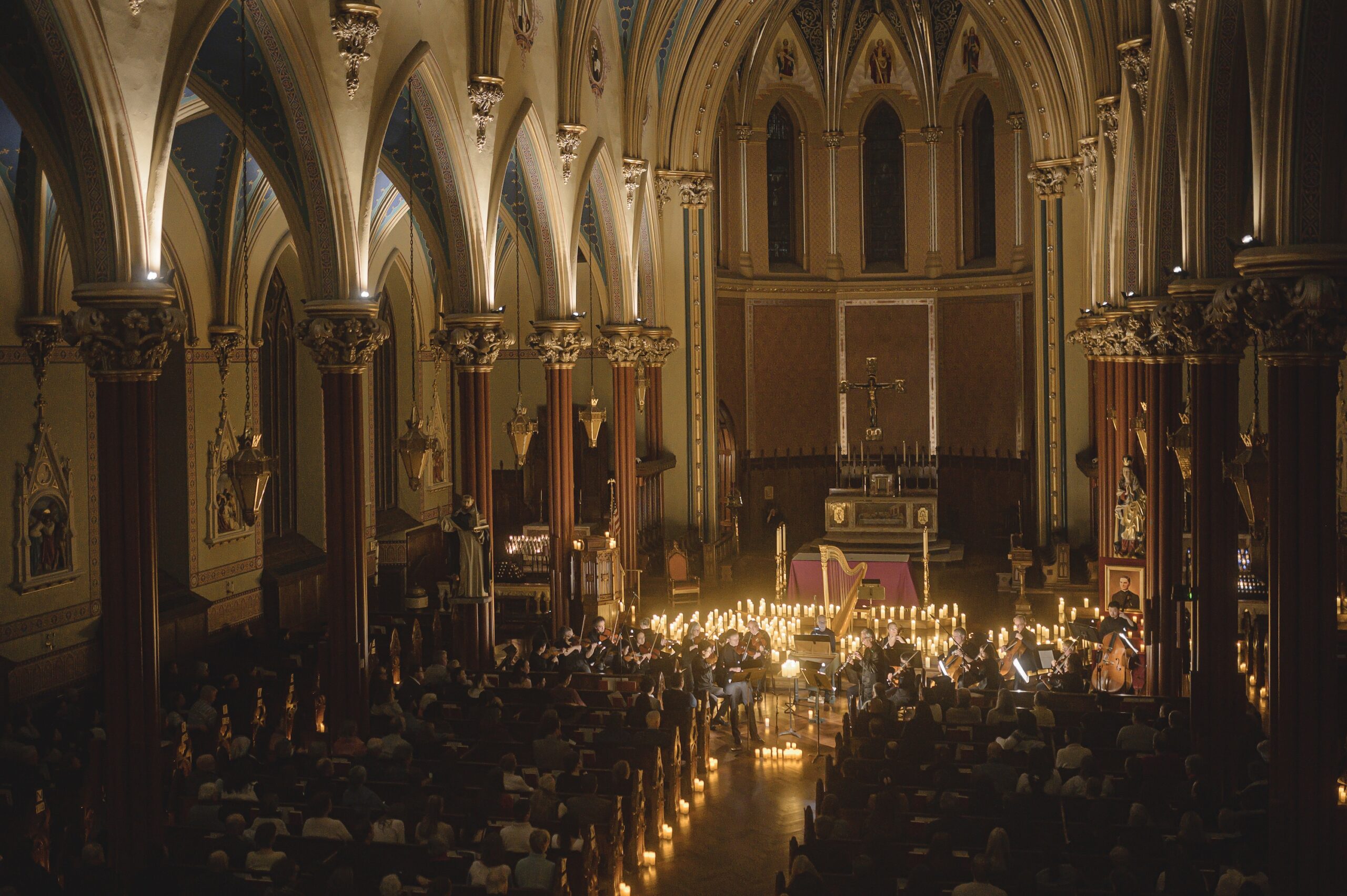 A small orchestra is illuminated in candlelight in the remarkably beautiful St. Mary's Church.